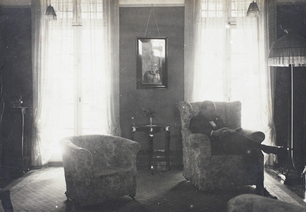 Harold Peck at home, reading