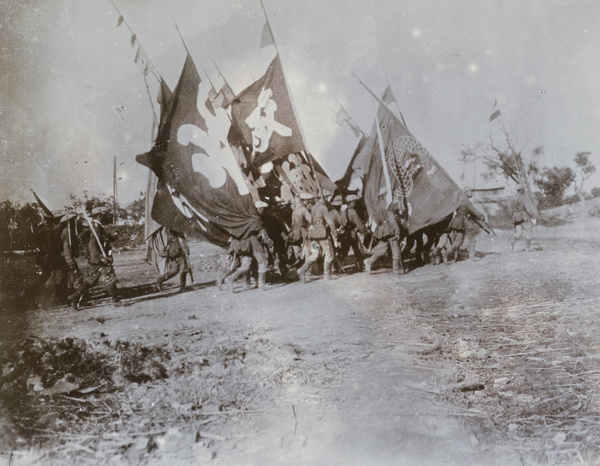 Soldiers processing with flags