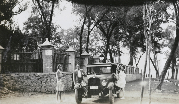 Touring party, beside a car, Peking