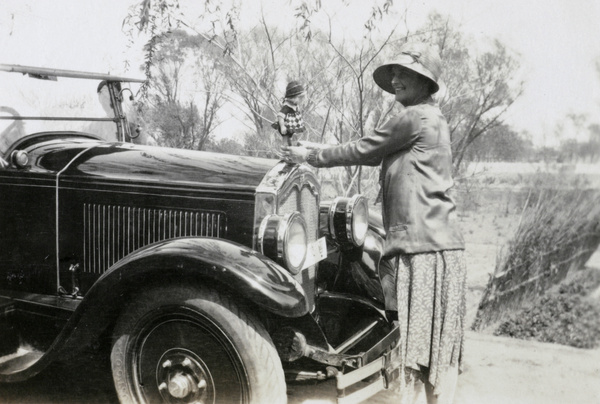 Rachel Lampson with a doll mascot for a car