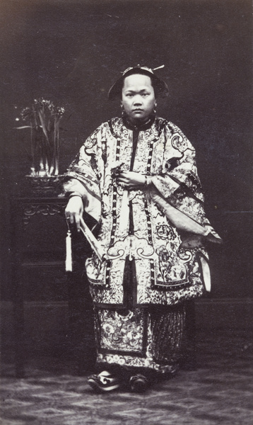 Portrait of a woman wearing a fine robe, with flowering bulbs