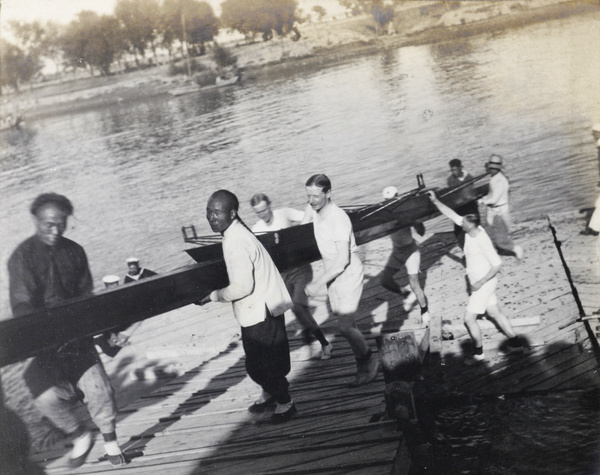 Carrying a rowing boat away from the river