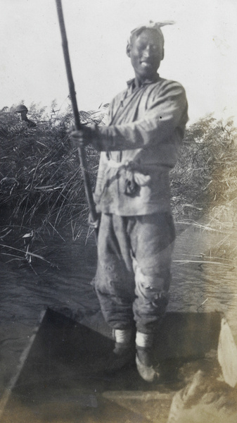 Punter and duck hunter among reeds in the background