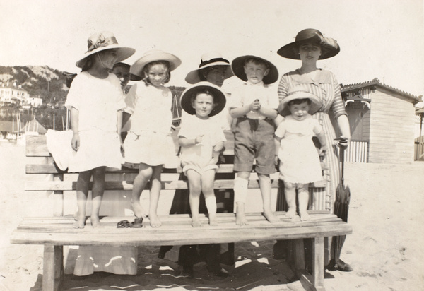 Esme Hutton Potts with children, on the beach, Qingdao