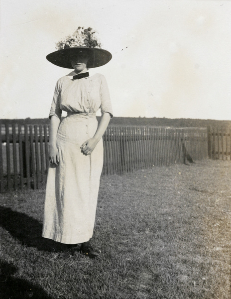 A woman by a fence