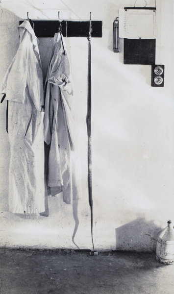 A snake skin hanging from a hook, with coats, Dairy Farm, Pokfulam, Hong Kong