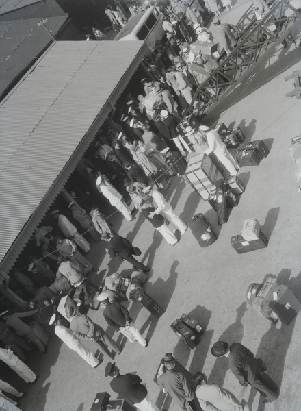 Ship passengers and luggage on quayside