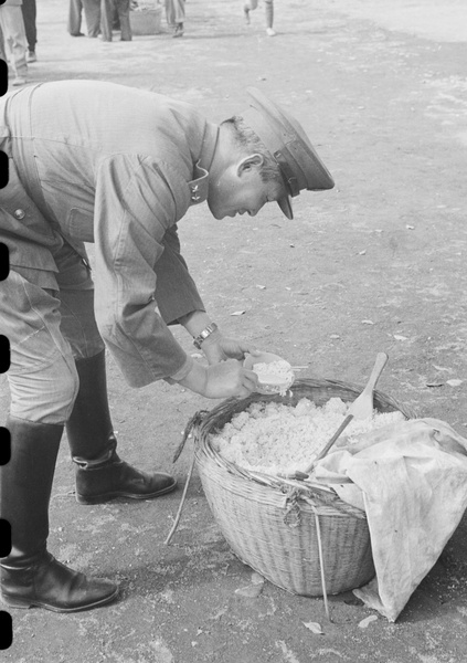 National Army officer helping himself to rice