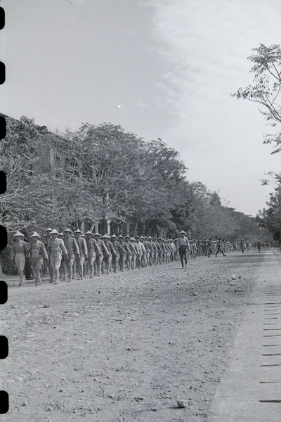 National Army soldiers marching along partly made road