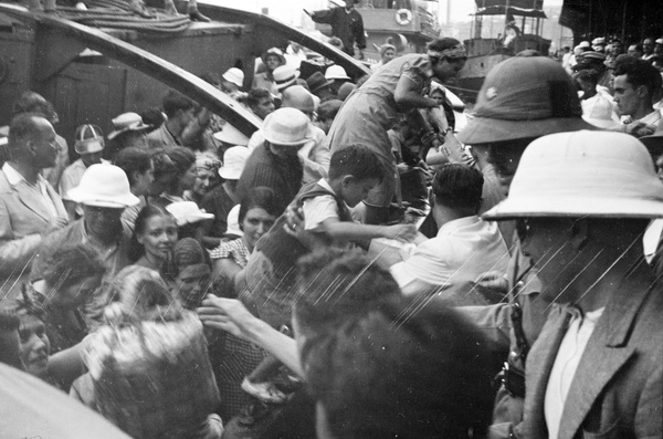 Children and bag handed onto a packed ferry