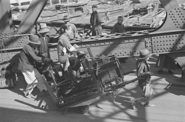 Woman and furniture on a handcart, Chekiang Road Bridge, Shanghai