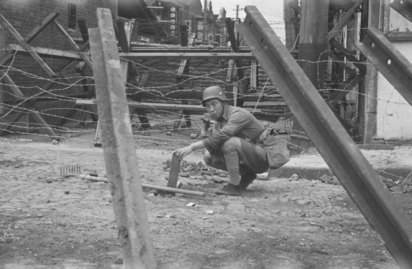 Nationalist soldier amid barbed wire and barricades