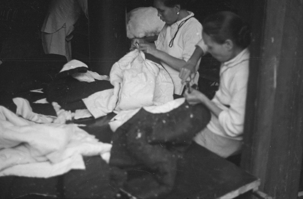 Women sewing quilted jackets, Shanghai