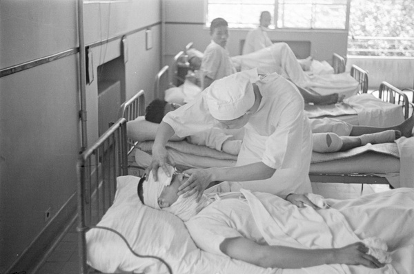 Doctor attending to a patient with head wounds, Shanghai