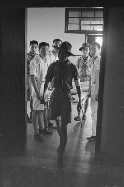 Boy scouts carrying stretcher in hospital, Shanghai