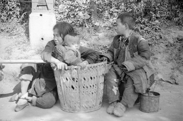 Woman and children at road side, Shanghai