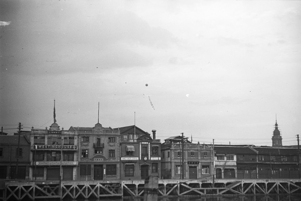 Balloon with banner above creekside properties, Shanghai