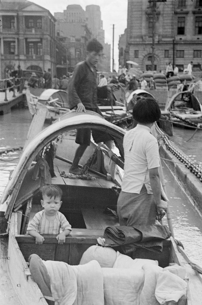 Family in sampan, off The Bund, Shanghai