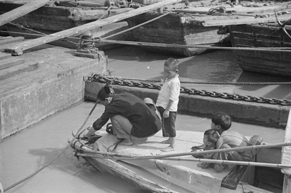 Woman and anchor, with family, near The Bund, Shanghai