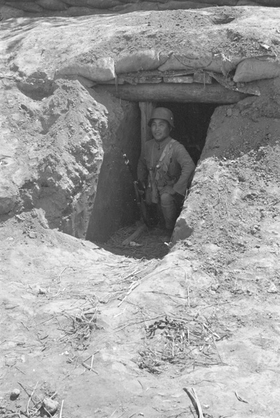 Nationalist soldier in dugout, Shanghai