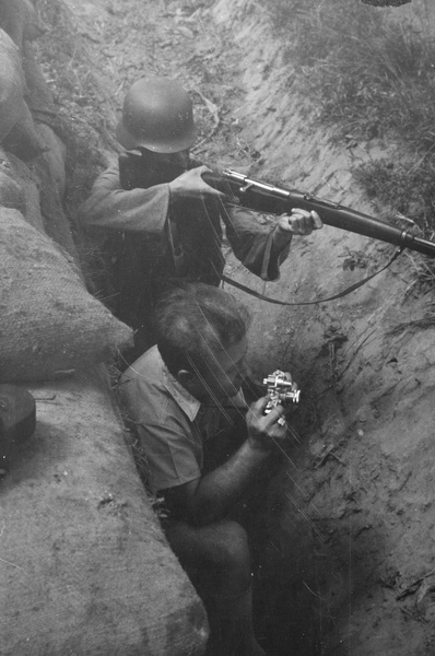 Nationalist soldier by dugout with photographer George Lacks, Shanghai