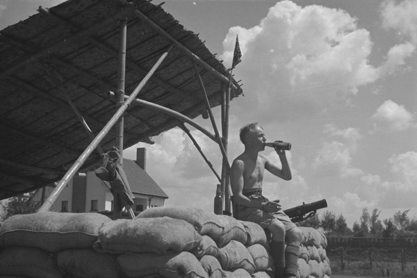 British soldier drinking beer at a guard post, Shanghai
