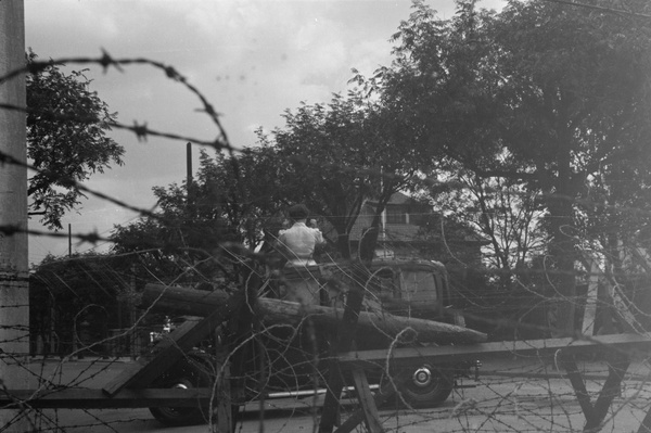 Women standing in a car by a British checkpoint, Shanghai