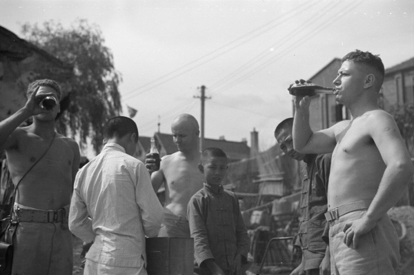 American marines drinking sodas, with children, Shanghai