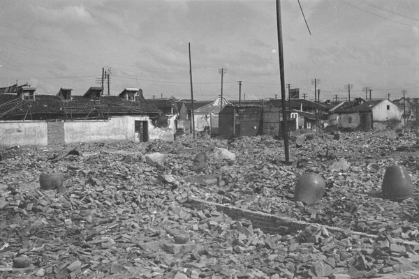 Water urns in bomb damaged district, Shanghai