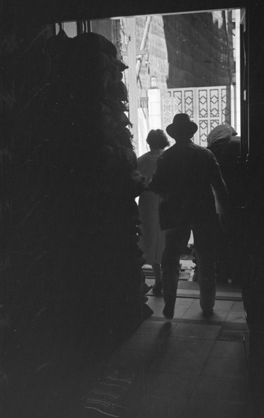 People by sandbagged doorway, Shanghai