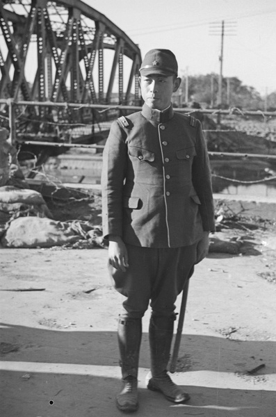 Japanese officer by bomb damaged Jessfield Railway Bridge, Shanghai