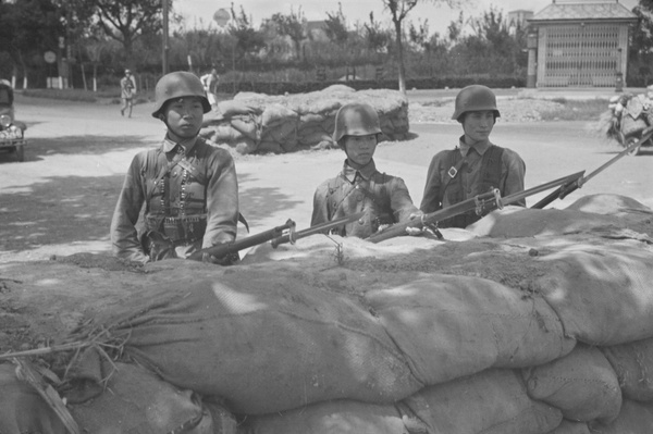 Nationalist soldiers at a barricade by a Shell petrol station, Shanghai