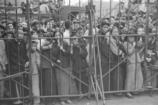 Refugees in front of the closed gates to the French Concession area, Shanghai