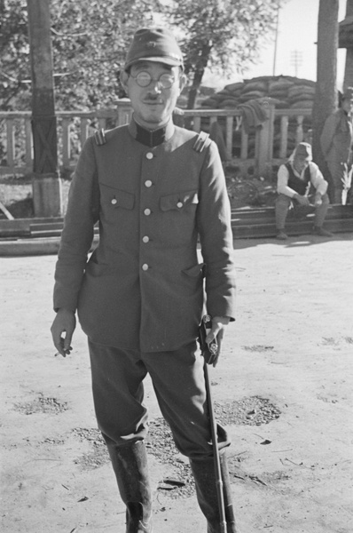 Japanese officer, with camera and cigarette, Jessfield Railway Bridge, Shanghai