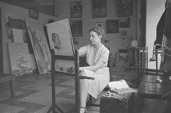 A woman posed by an easel in the studio of Victor Podgoursky, Shanghai