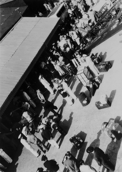 Ship passengers and luggage on quayside