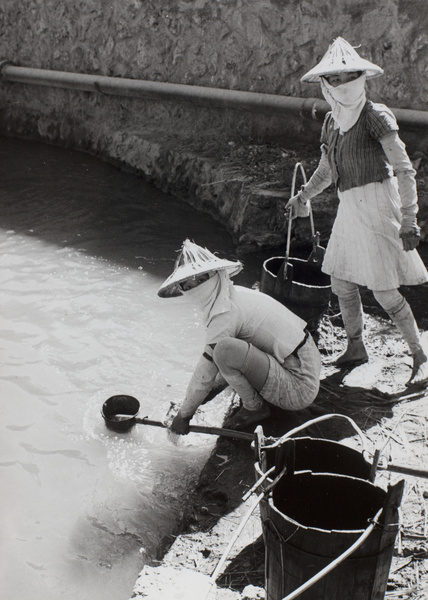 Women scoop up manured water, Taiwan