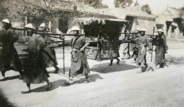 Sedan chair carried by eight men