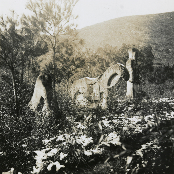 Stone horse sculpture beside road