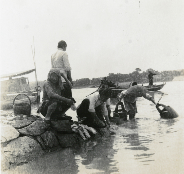 Women laundering and collecting water