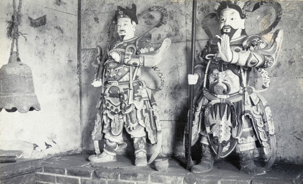 Temple guardians (shrine figures) and a bell