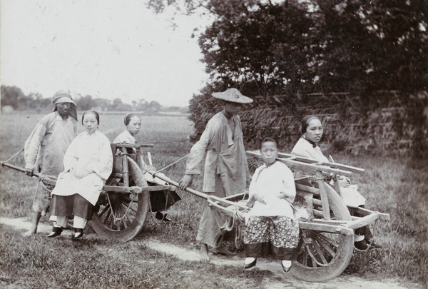 Four women travelling by wheelbarrow