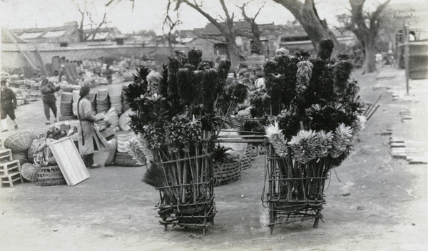 Selling feather dusters at a market