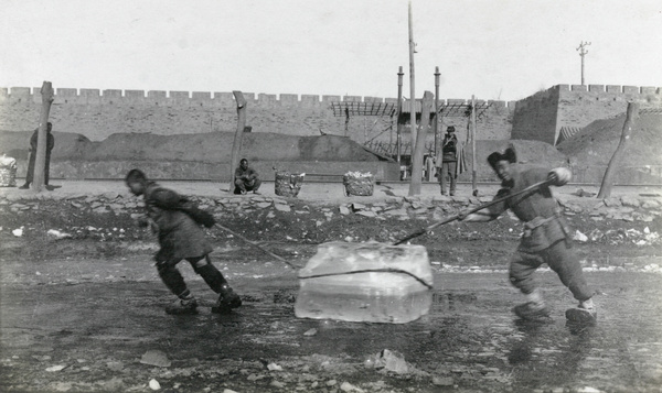 Moving a block of ice along the frozen moat, city walls, Beijing