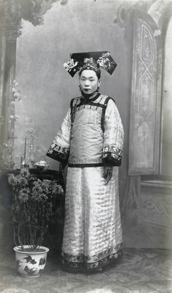 Studio portrait of a Manchu woman in fine traditional dress