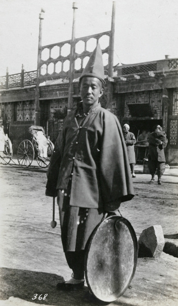 Musician with a gong, for a funeral procession