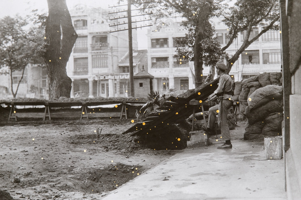 Soldier and defences around a building, Canton, June 1925