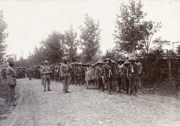 Road repair chain gang of prisoners with SMP guards, including Sikhs
