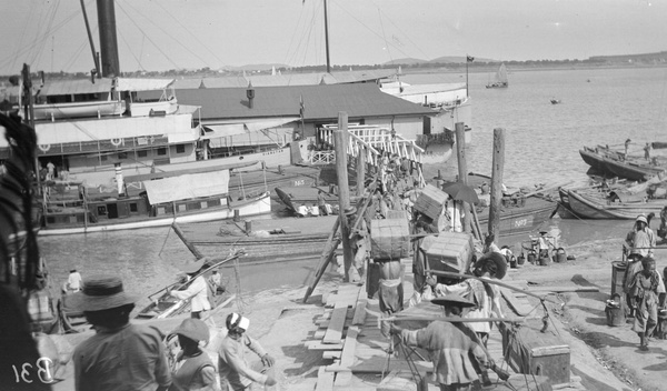 Loading goods at Butterfield and Swire hulks, Hankow