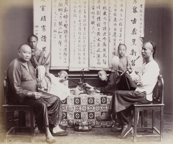 Smoking opium - a posed tableau